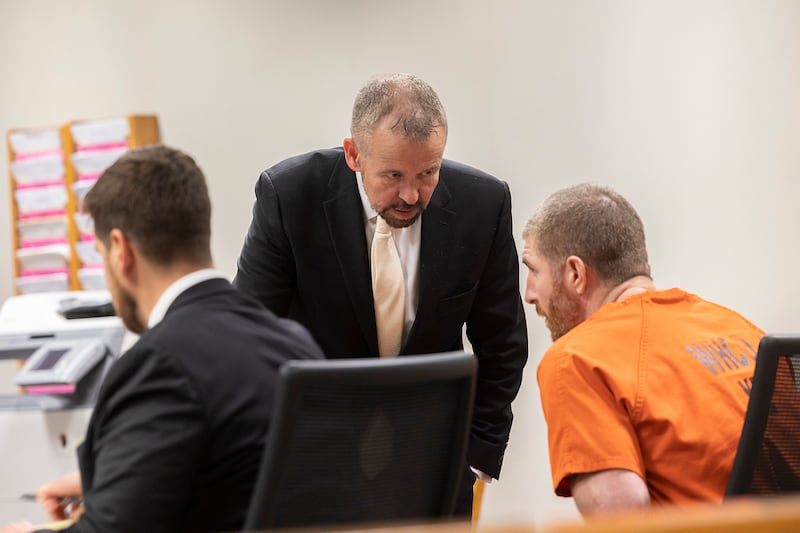 Jim Mertes speaks with his client Kyle Cooper Wednesday, May 14, 2025, in Whiteside County Court.