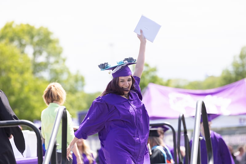 Sophie Bennett raises her diploma high Sunday, May 25, 2025, during Dixon High School’s graduation.