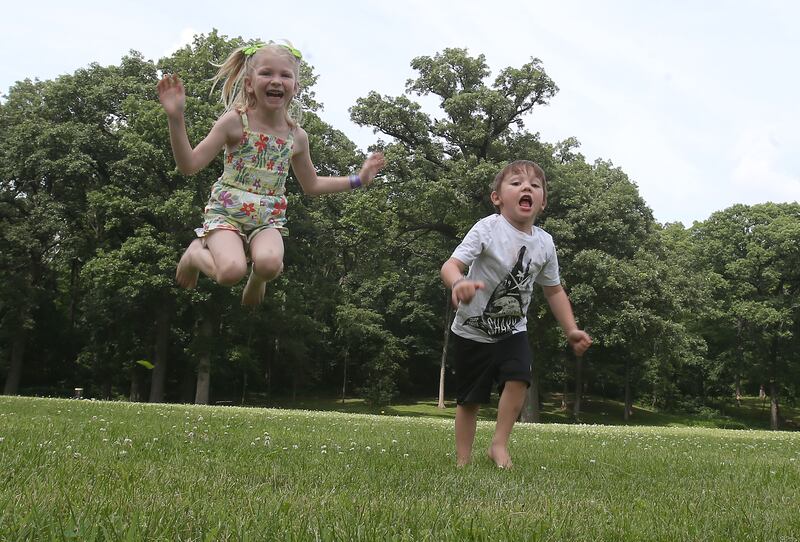Kaibrey and Kaison Crank, play in a open grassy area where the future home of Logan's Oasis Playground will be built on Monday, June 16, 2025 at Marilla Park in Streator. Their father Logan died in a tragic accident in 2023 at age 26. Ground for the playground will be broken this summer. Constellation, La salle Clean Energy Center donated $36,000 to the project. A fun is also established through Starved Rock Country Community Foundation. Logan's Oasis is a non-for-profit  organization with a beautiful mission to build a playground in Logan's memory that celebrates joy, inclusion and community at Marilla Park.