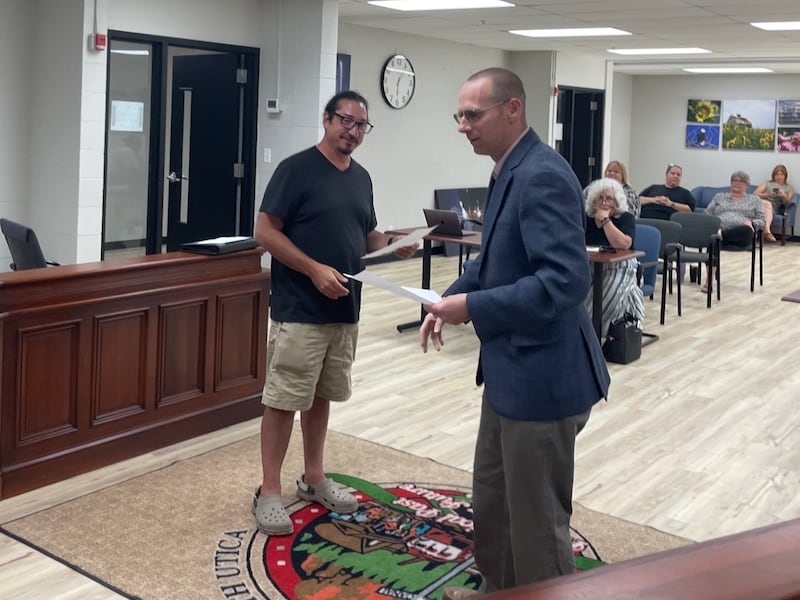 Utica Mayor David Stewart (right) introduces new village trustee Eric Bara after administering the oath of office Thursday, July 10, 2025.
