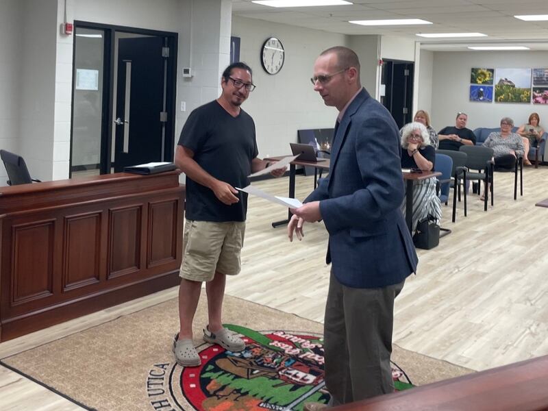 Utica Mayor David Stewart (right) introduces new village trustee Eric Bara after administering the oath of office Thursday, July 10, 2025.