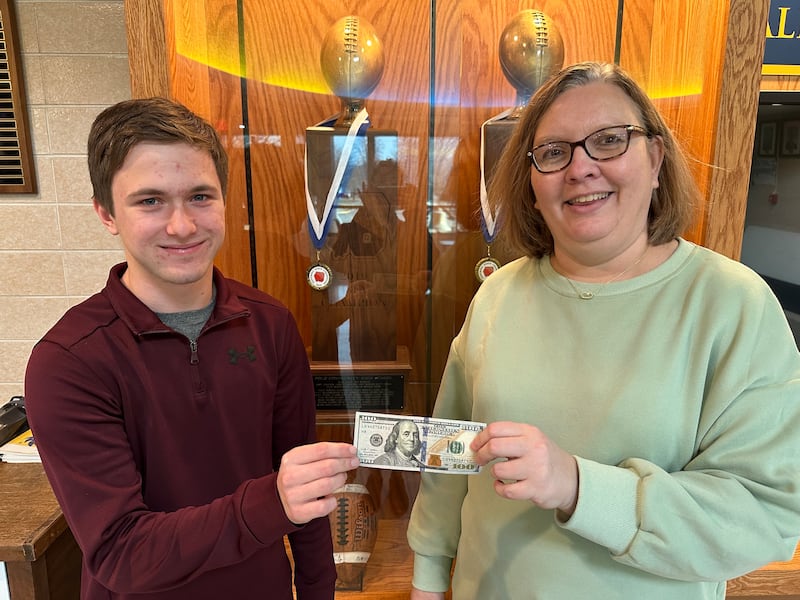 Joey Rowland was recently named the January Student of the Month at Polo Community High School. He is shown accepting a scholarship from Jenni Yingling of the Polo Schools Foundation.