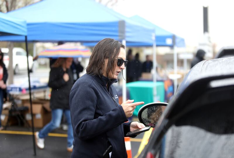 Kim Peterson gives out information during a drive-thru event to kick off the Kane County Health Department’s 988 Suicide and Crisis Lifeline awareness campaign on Friday, April 25, 2025 in the parking lot of the Kane County Circuit Clerk in St. Charles.