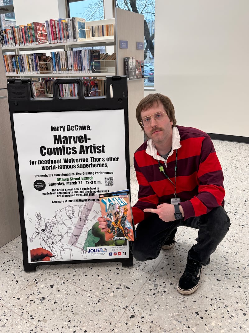 Patrick Maloney, adult services librarian at the Joliet Public Library, showcases a poster letting patrons know that
Marvel Comics artist Jerry DeCaire will be creating live on March 21 at the library, while discussing his techniques and the comic book industry.