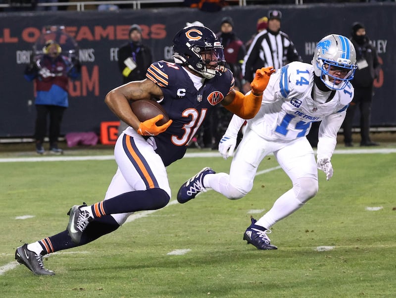 Chicago Bears safety Kevin Byard III runs by Detroit Lions wide receiver Amon-Ra St. Brown after intercepting a pass during their game Sunday, Jan. 4, 2026, at Soldier Field in Chicago.