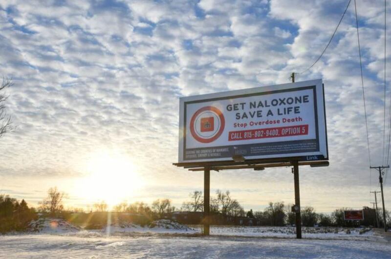 A billboard displays “Get naloxone, save a life” along with the number to call on East Court Street in Kankakee. With the help of opioid overdose education and the distribution of naloxone, also known as Narcan, Kankakee County saw a 52% decrease in overdose deaths last year, dropping from 34 to 20.