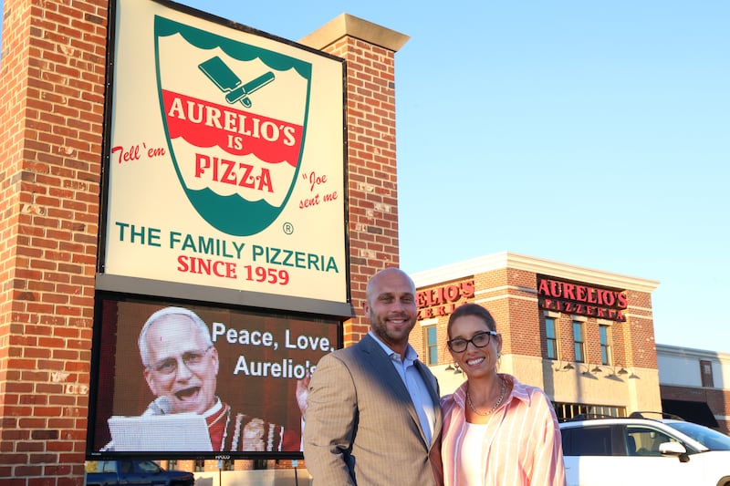 Ryan and Abby Magruder, new owners of Aurelio's Pizza in Bourbonnais, stand outside the 1600 N. Convent St. restaurant on Thursday, Oct. 23, 2025.