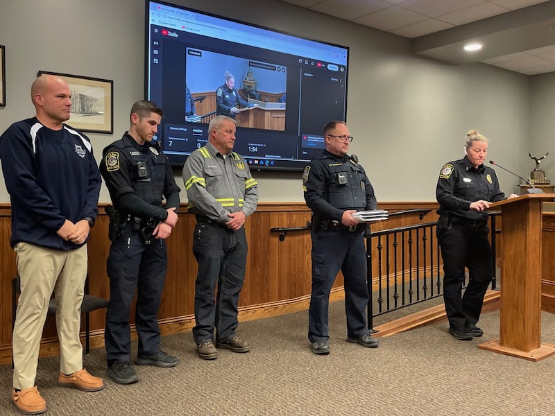 Peru Police Chief Sarah Raymond (right) commends Monday, Feb. 23, 2026, (from left) Community Service Officer Blake Frund, Officer Brendan Sheedy and electric foreman Brent Martin for their heroic actions at a Feb. 9 fire. Sgt. Scott DeGroot (second from right) holds the plaques.