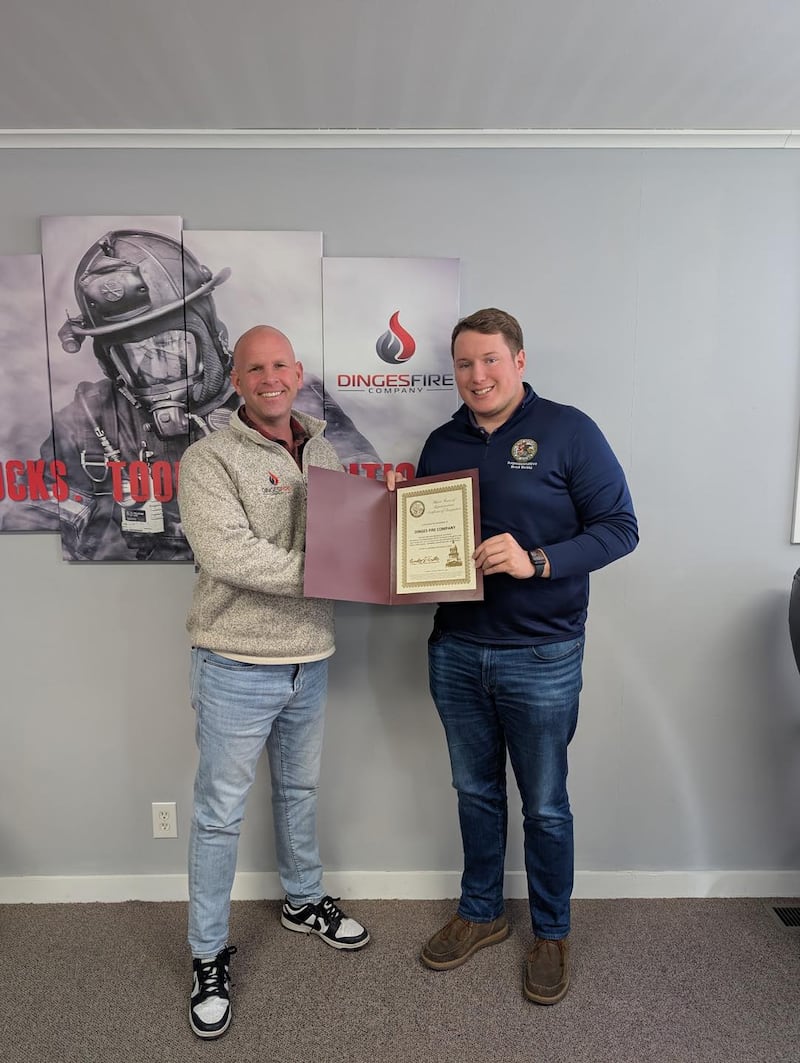 State Rep. Brad Fritts (right) presents Nick Dinges of Dinges Fire Company with a business highlight award.