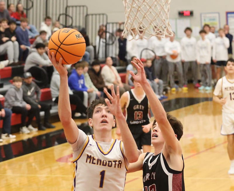 Mendota's Cole Tillman scores on a layup over Illinios Valley Central's Jackson Lopotko during the Colmone Classic on Friday, Dec. 12, 2025 at Hall High School.