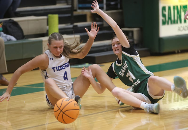 Princeton's Madie Gibson and St. Bede's Parker McClain fall to the floor while chasing a loose ball during the Class 2A Regional semifinal game on Tuesday, Feb. 17, 2026 at St. Bede Academy.