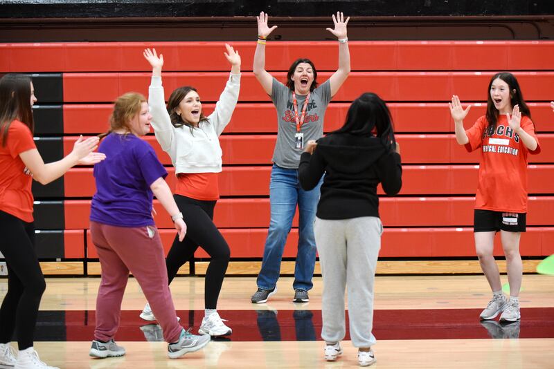 Bradley-Bourbonnais PE teacher and girls volleyball coach Leigh Reiniche (gray shirt) joins the celebration after Leah Mason scored a goal in soccer during an adapted PE class Friday, April 4, 2025. Joining in the celebration, from left, are Jocelyn Zettergren, Ella Schneider, Ella Walter and Emmeline Sovinski.