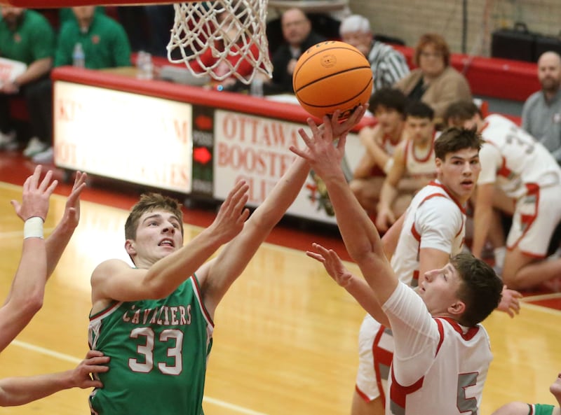 L-P's Gavin Stokes gets a shot off over Morton's Alex McKie during the Class 3A Sectional semifinal game on Tuesday, March 3, 2026 in Kingman Gymnasium at Ottawa High School.