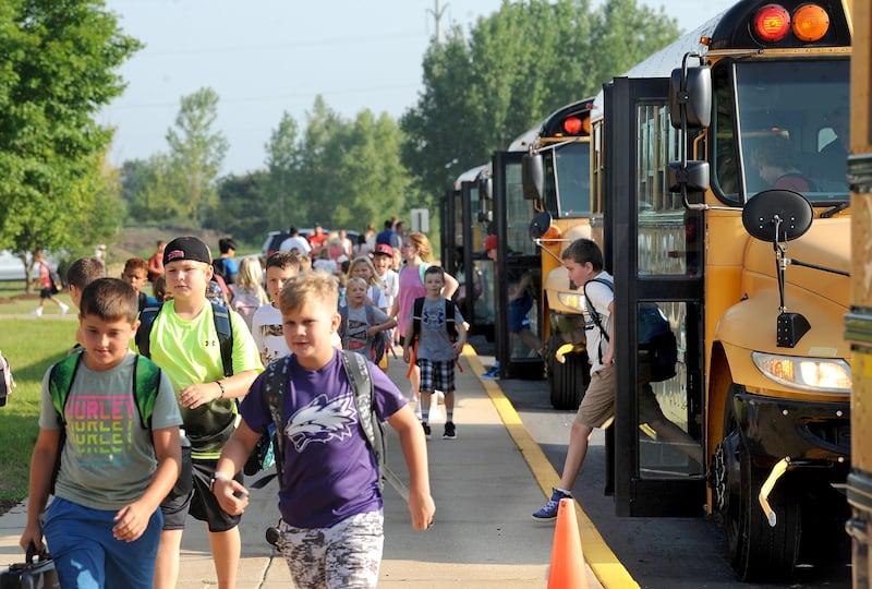 Buses arrive and let off the students on the first day of school at Grande Reserve Elementary in Yorkville on Thursday, Aug. 24, 2023.