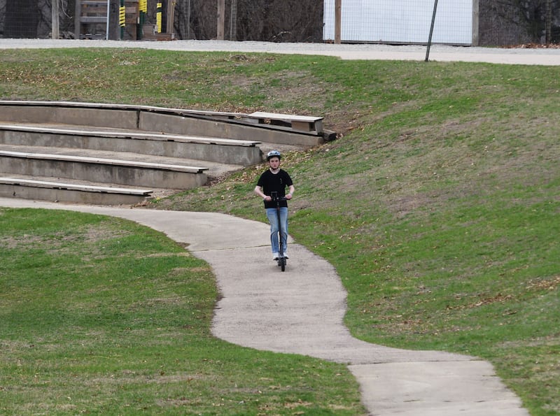 Levi Giller, 50, of Morrison rides his electric scooter on the path near Waterworks Park in Morrison on Saturday, March 29, 2025.