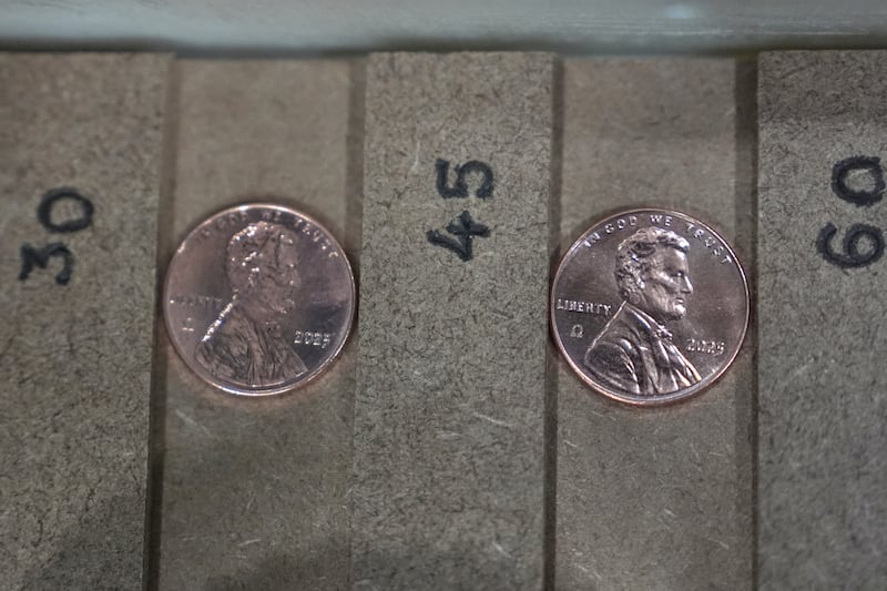 Two of the last five pennies pressed at the U.S. Mint are presented Nov. 12, 2025, during a news conference in Philadelphia.
