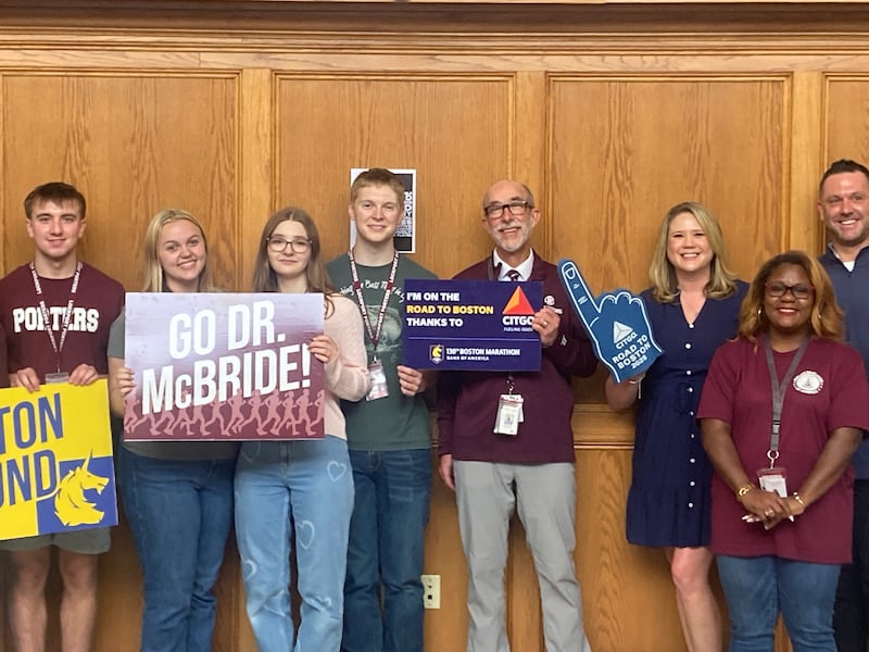 Robert McBride stands with students, staff, and CITGO Public Relations Manager Jen Hannon at his Boston Marathon surprise send off Friday, April 17, 2026.