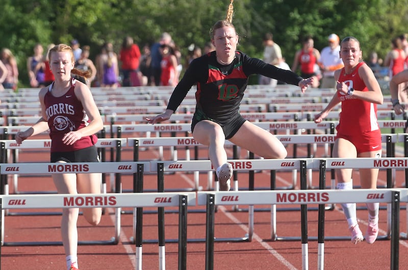 (From left) Morris's Leah Martin, L-P's Elli Sines and Ottawa's Isabelle Markey compete in the 100 meter hurdles during the Interstate 8 Conference girls track championship on Friday, May 9, 2025 at Morris High School.