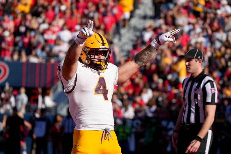 Arizona State running back Cam Skattebo (4) celebrates scoring a touchdown during the first half of an NCAA college football game against Arizona, Saturday, Nov. 30, 2024, in Tucson, Ariz. (AP Photo/Samantha Chow)