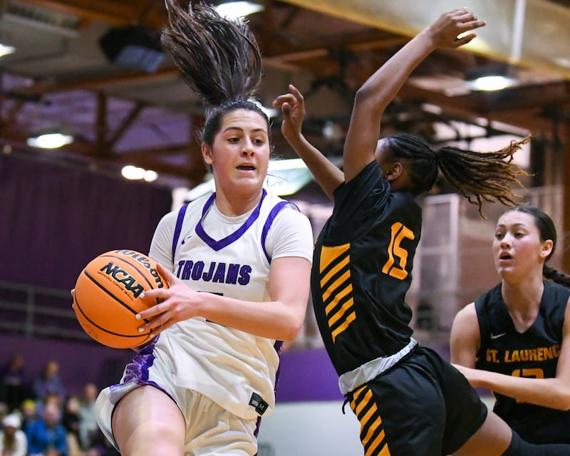 Downers Grove North's Campbell Thulin (5) gets a rebound during the 4A regional championship game on Thursday Feb. 19, 2026, while being defended by St. Laurence's McKenzie Saffold (15) held at Downers Grove North High School.