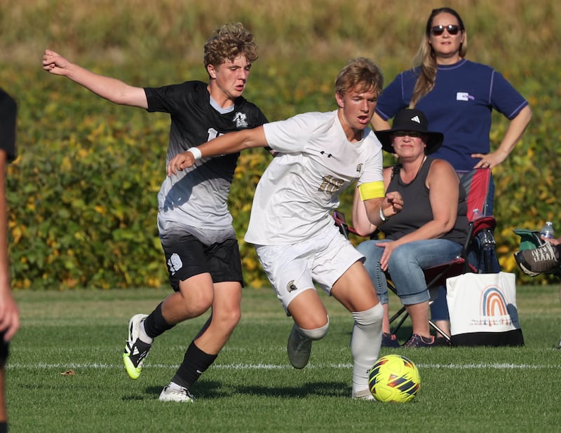 Sycamore's Gavin Crouch (right) tries to hold off Kaneland's Isaac Stoltzner during their game Wednesday, Sept. 16, 2025, at Kaneland High School in Maple Park.