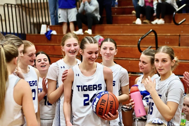 enior Keighley Davis received a commemorative basketball after becoming Princeton's all-time leading scorer, boys or girls, Monday night at Prouty Gym. She score 29 points to lead the Tigresses to a 49-39 win over Marquette.