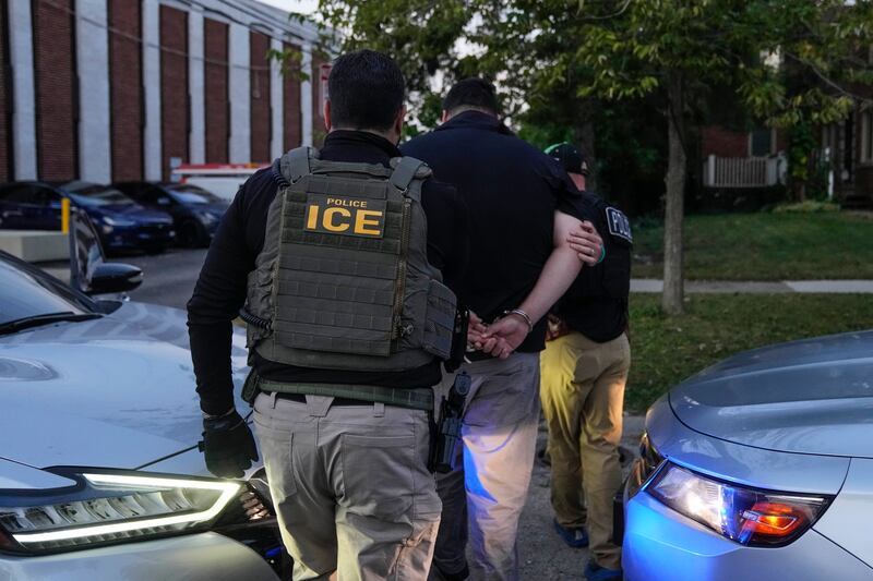 U.S. Immigration and Customs Enforcement agents make an arrest during an early morning operation in Park Ridge, Ill., Friday, Sept. 19, 2025. (AP Photo/Erin Hooley)
