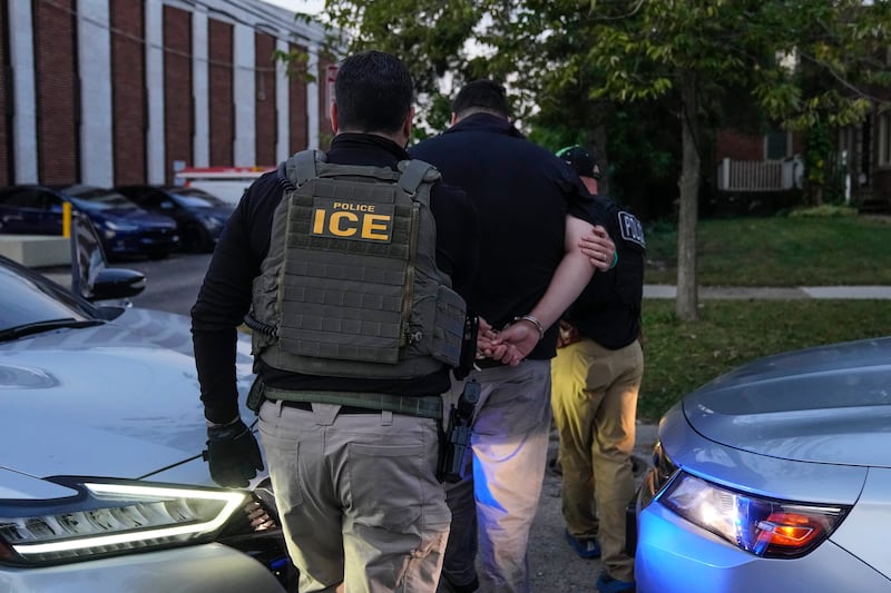 U.S. Immigration and Customs Enforcement agents make an arrest during an early morning operation in Park Ridge, Ill., Friday, Sept. 19, 2025. (AP Photo/Erin Hooley)