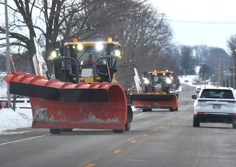 Two Ogle County Highway Department snow plows head east on Pines Road en route to their garage on state Route 2, south of Oregon, after a long day of clearing county roads on Sunday, Nov. 30, 2025. State, county, and township trucks were busy over the weekend clearing 12 inches of snow that fell on Saturday.