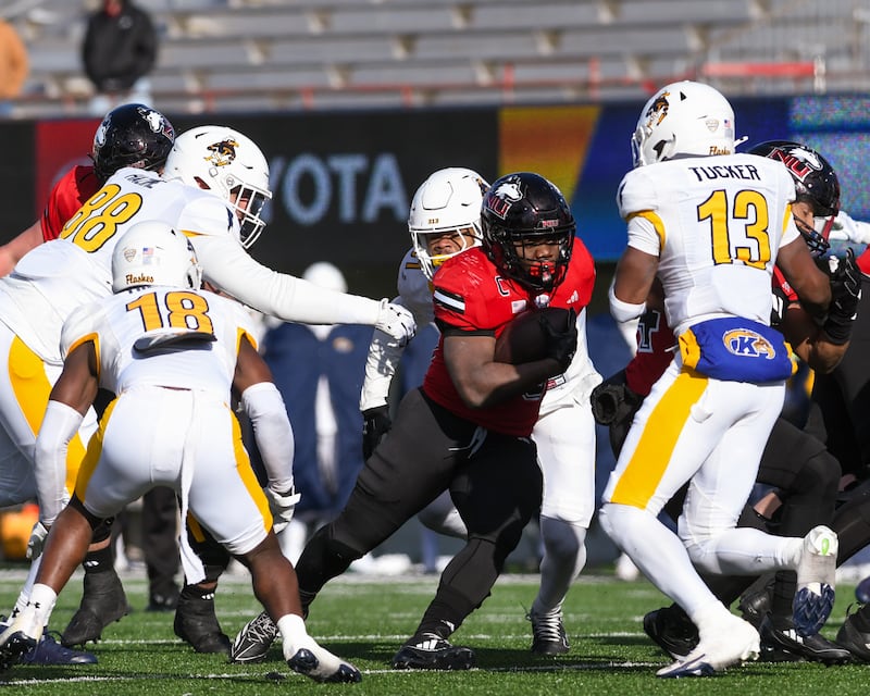 Northern Illinois University's running back Chavon Wright (10) runs the ball for some yards before being brought down by Kent State defenders during the game on Friday Nov. 28, 2025, held at Huskie Stadium in DeKalb.