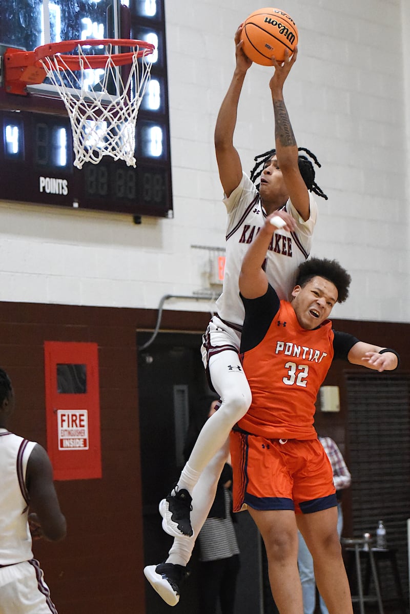 Kankakee's Lincoln Williams, top, leaps over Pontiac's Riley Johnson to send home a slam dunk during the IHSA Class 3A Morris Regional semifinals Wednesday, Feb. 26, 2025.