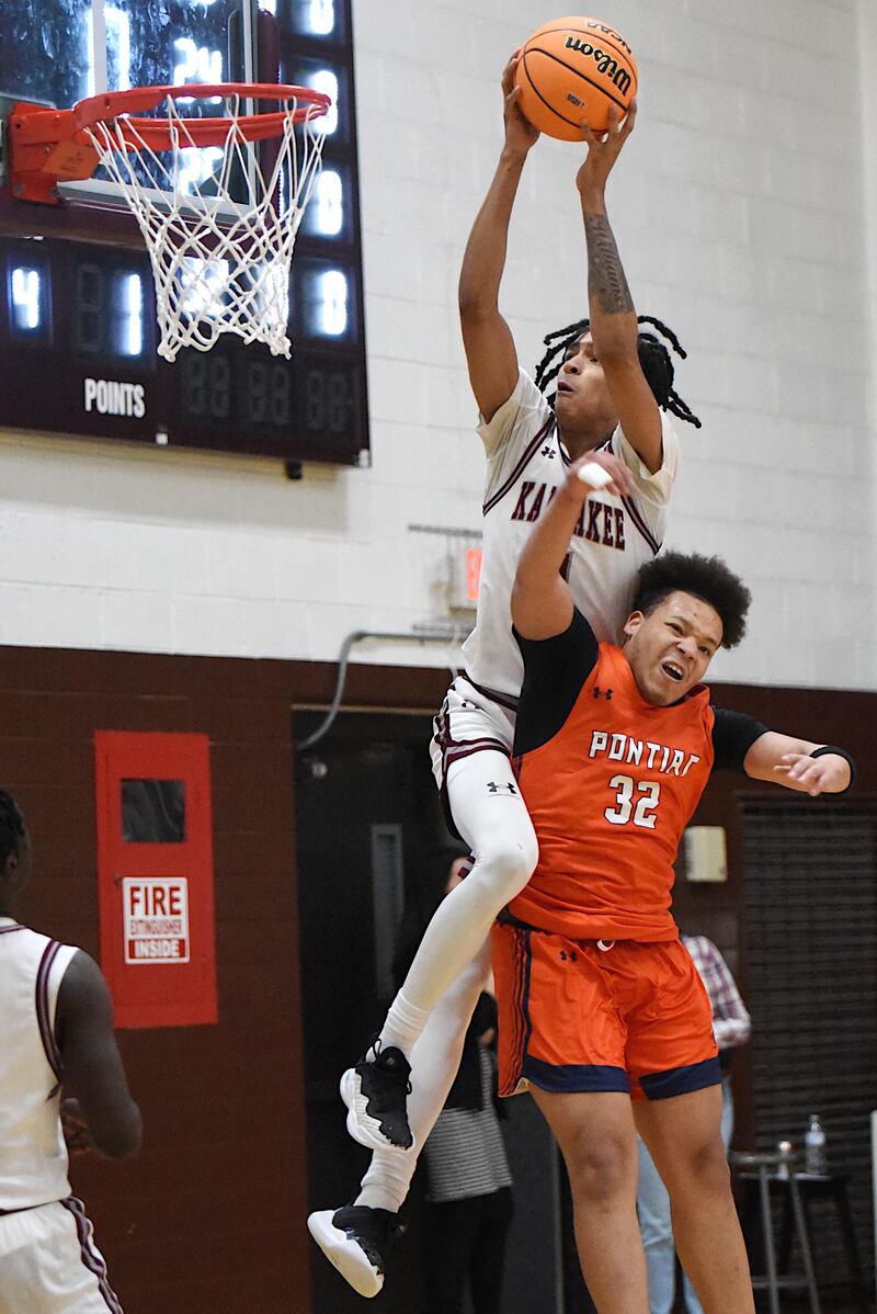 Kankakee's Lincoln Williams, top, leaps over Pontiac's Riley Johnson to send home a slam dunk during the IHSA Class 3A Morris Regional semifinals Wednesday, Feb. 26, 2025.