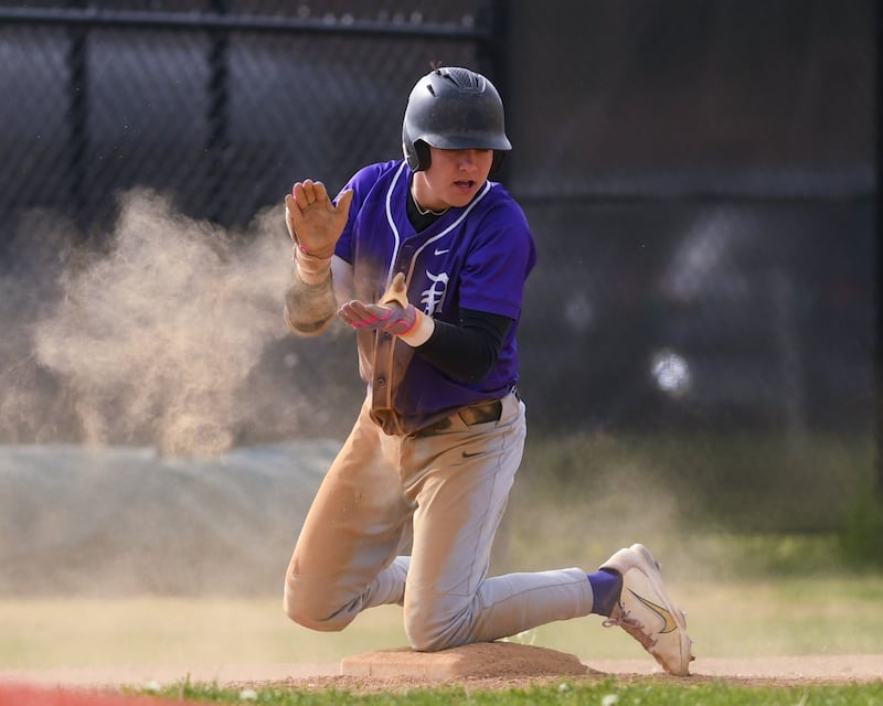 Downers Grove North's Brady Schallmoser (15) celebrates his triple during the game on Monday May 19, 2025, while taking on York High School in Elmhurst.