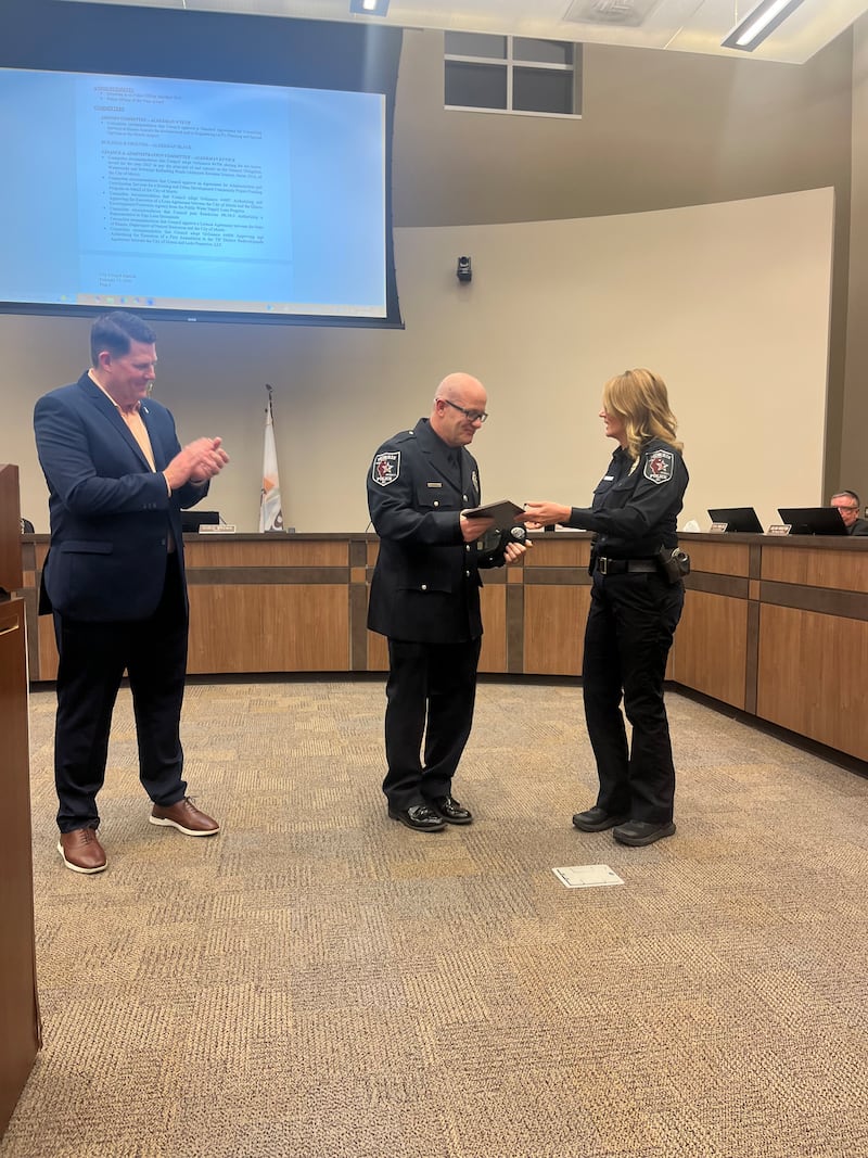 Officer Scott Evans receives his Officer of the Year award from Police Chief Alicia Steffes on Monday, Feb. 17, 2026.