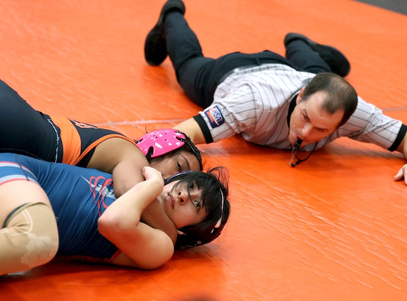 DeKalb’s Alex Gregorio-Perez pins South Elgin’s Anni Romo Wednesday, Nov. 27, 2024, during their 105 pound match at DeKalb High School.