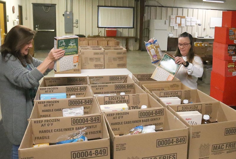 Mary Jo Credi Executive Director at the Illinois Valley Food Pantry, fills boxes of food with Trinity Roark on Tuesday, Oct. 28, 2025 at the Illinois Valley Food Pantry in Peru. Food shortage will worsen local food pantries due to the the shutdown.