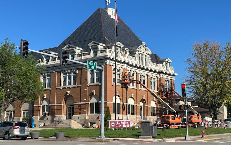 Crews work on tuck-pointing bricks on the exterior of the La Salle City Hall on Tuesday, April 30, 2024.