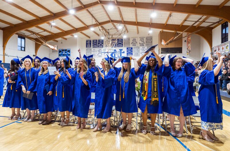 Newman graduates celebrate and flip their tassels after receiving their diplomas Wednesday, May 21, 2025, during commencement.