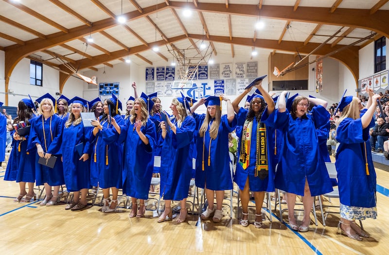 Newman graduates celebrate and flip their tassels after receiving their diplomas Wednesday, May 21, 2025, during commencement.