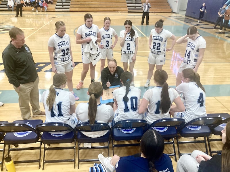 BV coach Jon Henegar huddles with the Storm between quarters of Saturday's 1A regional play-in game at the Storm Cellar. The Storm scored the first 26 points of the game on the way to dominating 51-11 win over Morrison.