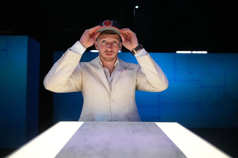 Oregon defensive back Dillon Thieneman puts on a hat after being chosen by the Chicago Bears with the 25th overall pick during the first round of the NFL football draft, Thursday, April 23, 2026, in Pittsburgh. (AP Photo/Jeff Roberson)