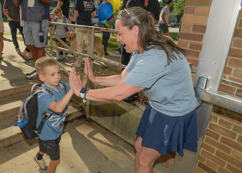 Davis Elementary STEM teacher Megan Oster welcomes students on the first day of class in St. Charles on Wednesday, Aug 13, 2025.