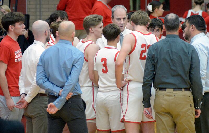 Ottawa boys basketball head coach Mark Cooper addresses the team during a timeout in this file photo.