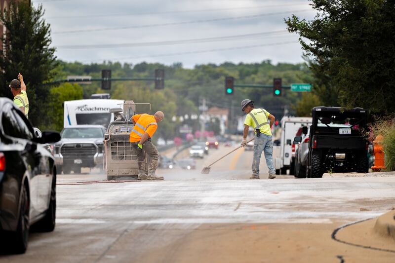 Workers from Helm Construction make improvements to the crosswalk at the corner of Peoria Avenue and Second Street on Thursday, Aug. 21, 2025, in Dixon. The intersection is one of seven getting the renovation.