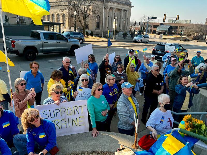 A crowd gathers along Dixon's Peoria Avenue during a vigil in support of Ukraine on March 13, 2025.