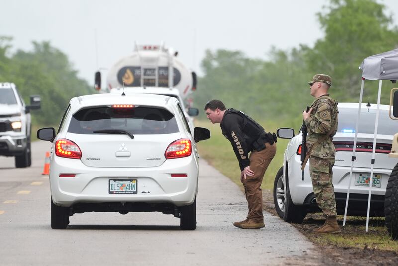 Police check cars arriving at the "Alligator Alcatraz," a new migrant detention facility at the Dade-Collier Training and Transition facility, Wednesday, July 2, 2025, in Ochopee, Fla. (AP Photo/Marta Lavandier)