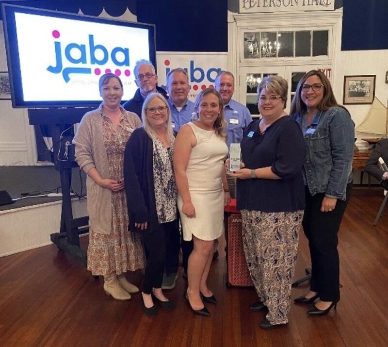 Staff members of First Secure State Bank of Johnsburg pose with the Community Impact Award, given the Johnsburg Area Business Association in October 2025.