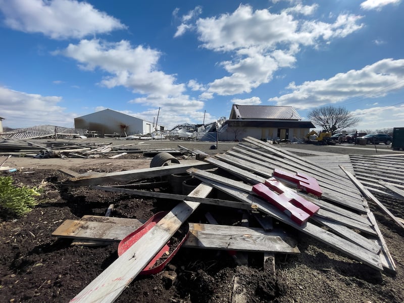 Letters from the Tholens' Landscape & Garden Center fence sign lay among the debris at the business along South Schuyler Avenue on March 13, 2026, following the March 10 tornado that caused widespread destruction in Kankakee County.