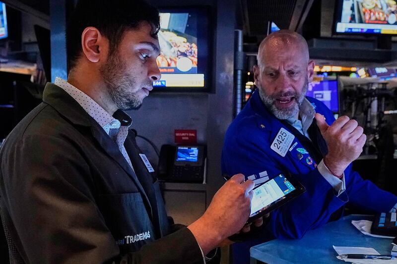 Trader Nial Pawa, left, and specialist Meric Greenbaum work on the floor of the New York Stock Exchange, Tuesday, May 6, 2025. (AP Photo/Richard Drew)