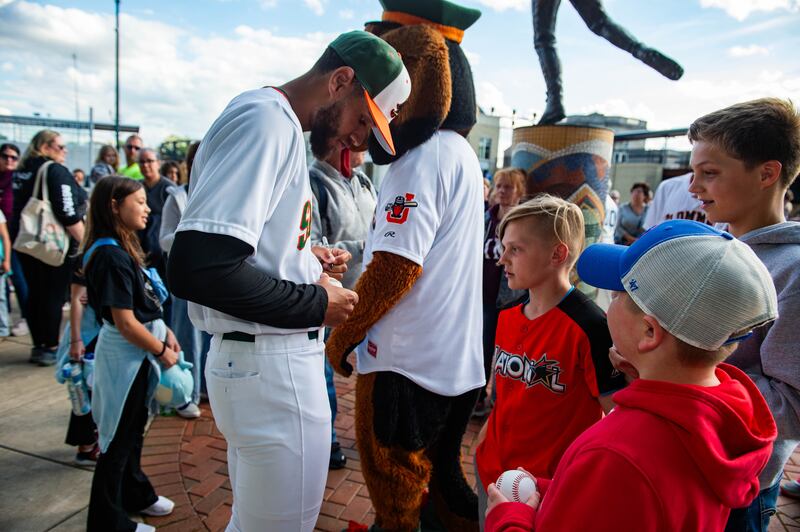 Joliet Slammers player David Harrison signs a ball for fansduring the Joliet Slammers home opener Friday May 10, 2024 at Duly Health and Care Field in Joliet